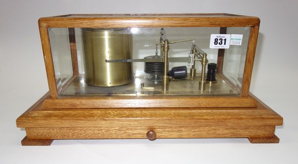 An oak cased barograph by Negretti and Zambra, early 20th century, with applied plaque reading 'Regency Barograph', with ten aneroids and a jewelled m