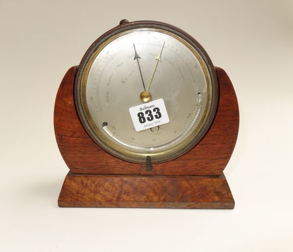 A brass cased table aneroid barometer, presentation engraved to the rear and dated 1862, housed in a mahogany and walnut frame, 12.4cm diameter, toget