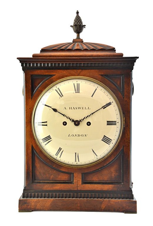An early Victorian mahogany cased mantel clock, the eight inch white painted dial detailed 'A Haswell, London', with pineapple finial and foliate cast