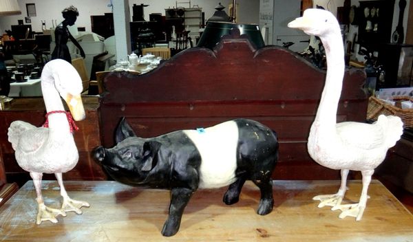 A 20th century bronze model of a pheasant, a wooden model of a pig and two cast metal models of geese.