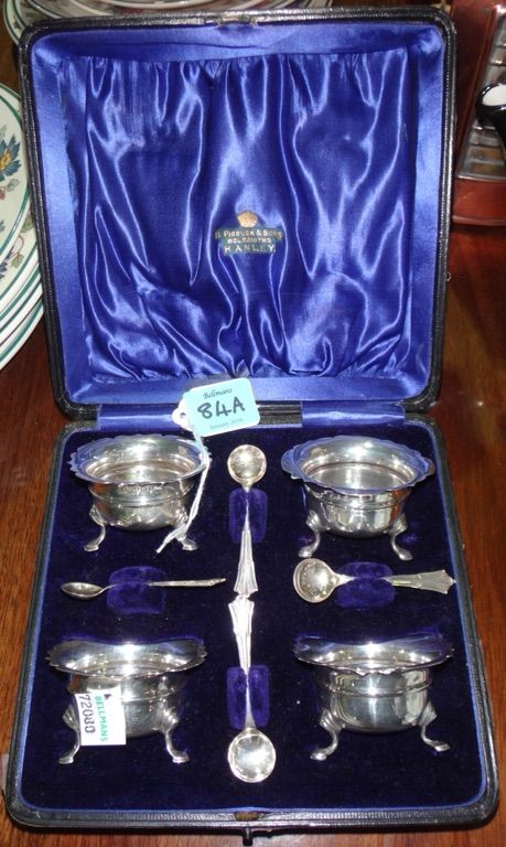 A set of four silver salts and Dubarry pattern spoons, Birmingham 1909, in a fitted case, Pidduck & Sons, Hanley.