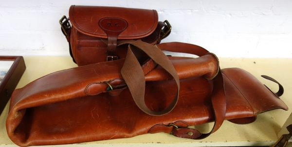 A leather and sheepskin lined gun slip, monogrammed 'D.C.', and a leather cartridge bag, also monogrammed (2).