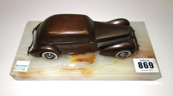 'Cord 810'; a patinated and silvered bronze model of a car, circa 1937, modelled and cast as the American streamlined car, mounted on an onyx rectangu