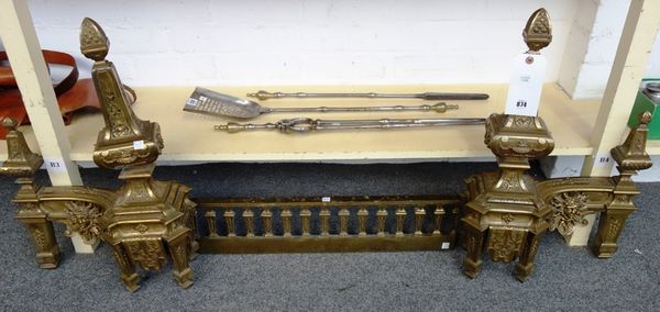A Victorian gilt bronze adjustable fire kerb, with twin shaped finials cast with urns and swags, united by a railed centre plinth, 60cm high.