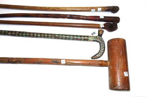 A Pitcairn walking stick, 19th century, the hardwood pommel carved as a clenched fist and detailed 'Pitcairn Island', 83cm, together with three other