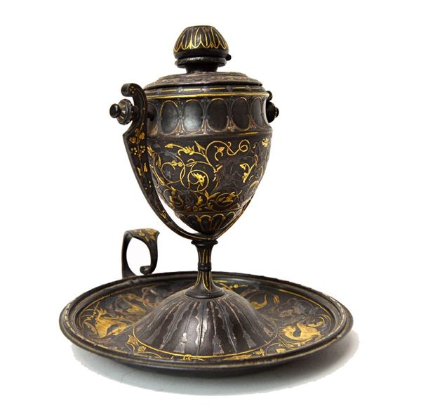 A Continental patinated metal oil lamp, 19th century, the burner body of urn form, on a gimble frame with a dished base and shaped gilt metal ring han