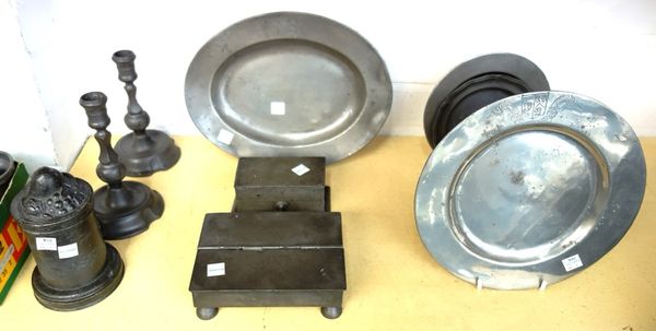 A quantity of pewter wares, including; a late 17th century plate with armorial crest, 24cm diameter, a Georgian desk stand, an early Victorian jelly m