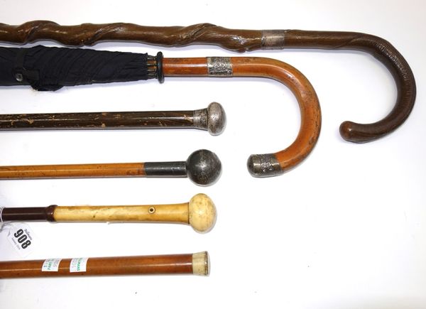 A parasol, one ivory topped walking cane, an umbrella with a silver mount, and three further canes with silver mounts.  (6).