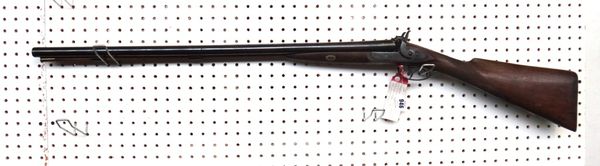 A double barrel percussion shotgun, circa 1850, with plain steel barrels and lockplate and a chequered walnuts stock.