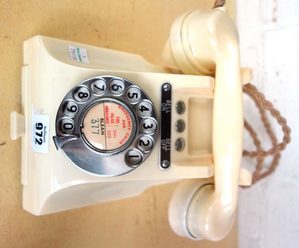 A 328f ivory coloured bakelite telephone, with three button blanks and exchange drawer to the front.