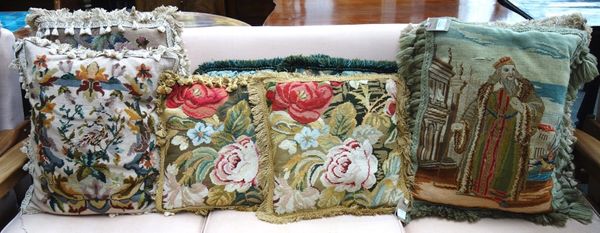 A collection of nine tapestry cushions.
