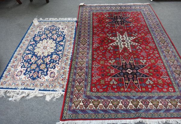 An Indian rug of Perepedil design, the madder field with three stars, minor motifs, an ivory border, 190cm x 130cm together with an Esfahan mat, the i