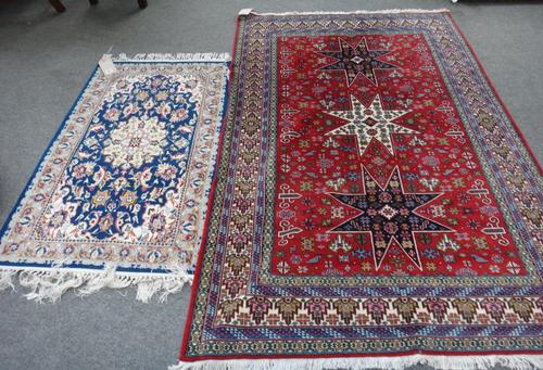 An Indian rug of Perepedil design, the madder field with three stars, minor motifs, an ivory border, 190cm x 130cm together with an Esfahan mat, the i