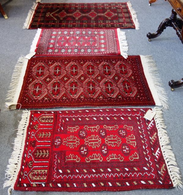 A Beluchistan rug, the madder field with an interconnecting design, 130cm x 80cm, together with an Afghan prayer rug with a madder mehrab and three ho