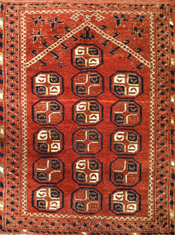 An Afghan prayer rug, the madder mehrab with lantern and arch above, 120cm x 81cm, together with a Beshir prayer rug with three columns of guls in meh
