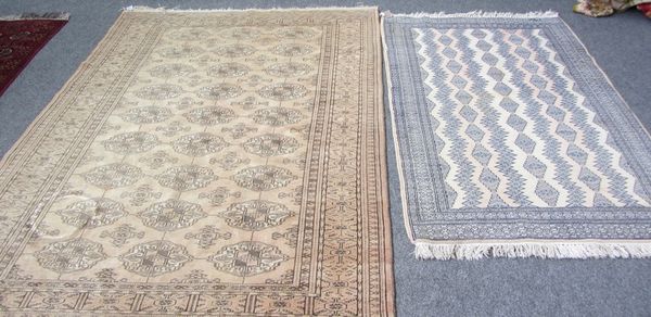 A Turkeman rug, the washed madder field with three columns of nine gals, supporting crosses; a sunburst border, 223cm x 141cm; and a Pakistan rug, ivo