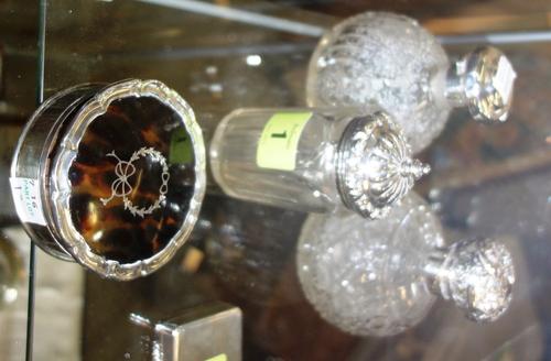 A group of silver mounted wares, comprising; a tortoiseshell and silver circular shaped trinket box, Birmingham 1919, two silver lidded and cut glass