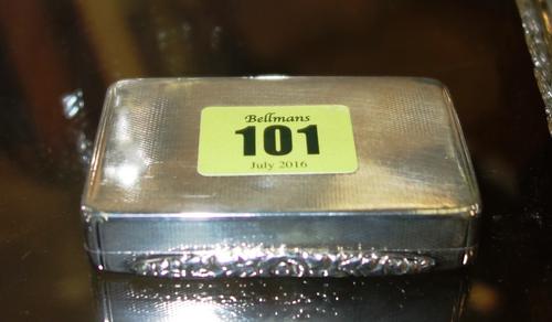 A George IV silver snuff box of rectangular form, with engine turned decoration and cast floral thumbpiece, by Thomas Shaw, Birmingham 1823.