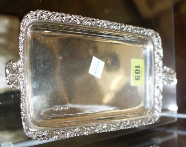 A Victorian silver dressing table tray, of twin handled rectangular form, with pierced scrolling border, Sheffield 1897.