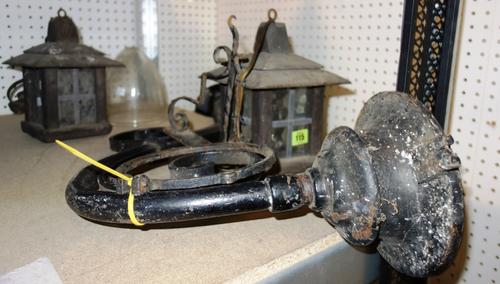 A pair of wrought iron lanterns and a large wrought iron light bracket and a glass shade. (4)