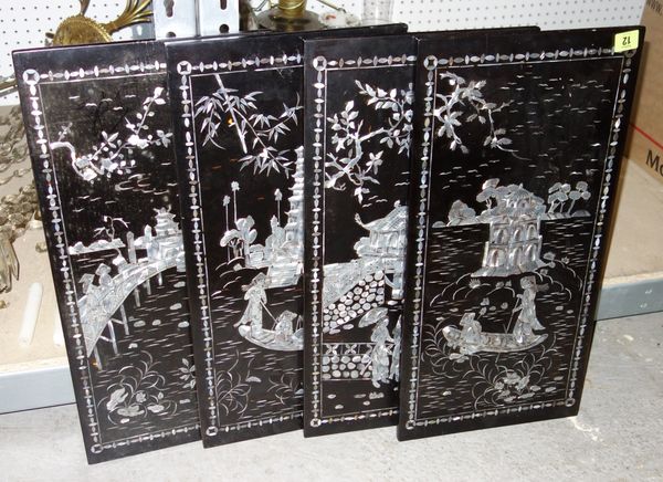 A group of four 20th century Oriental black lacquer and mother of pearl inlaid panels. (4)