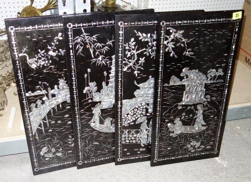 A group of four 20th century Oriental black lacquer and mother of pearl inlaid panels. (4)