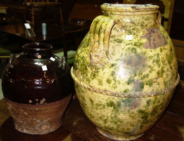 A large green and yellow pottery vase and a treacle glaze vessel. (2)