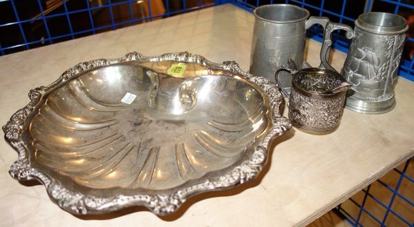 An Indian silver embossed beaker decorated with a lion, together with two pewter tankards and a plated dish. (4)