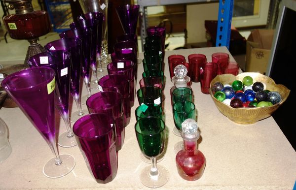 A quantity of assorted coloured drinking glasses and a group of marbles.
