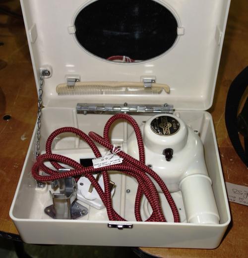An Ormond 1950's hair dryer, model E1022, with cream Bakelite body and vanity case, (including a comb).