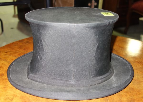 A black opera top hat by Woodrow 11 Market Street Manchester, bears initials 'D.C.P'.