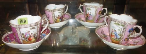 A group of four Dresdon style cups and saucers decorated with floral and figural panels. (qty)