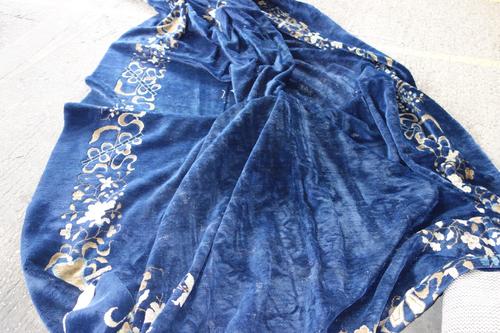 A Chinese carpet, the dark indigo field with four delicate floral sprays and central vase motif complementary floral border 395cm x 303cm.