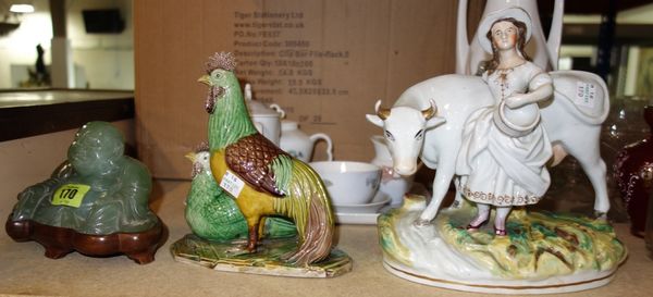 A green hardstone figure of Buddha on a stand, together with an Oriental model of chickens and a Staffordshire model of a cow and girl. (3)
