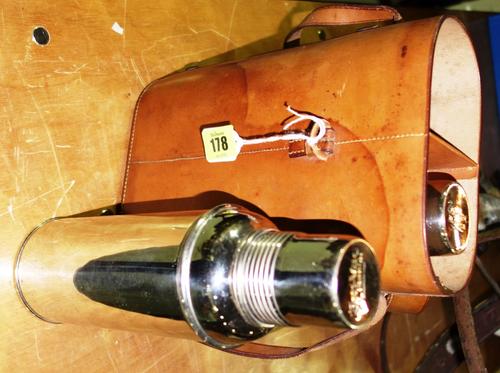 A pair of Zon-Vac chrome plated flasks within a tan leather case, with strap.