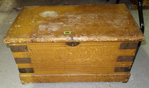 A Victorian scumbled pine box, with hinged lid and metal straps, 61cm wide.