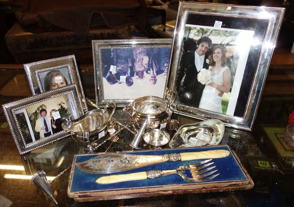 A group of silver plated wares, comprising; a cased pair of Victorian fish servers with ivory handles, four plated photograph frames, two snuffing con