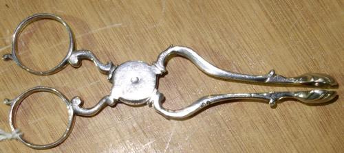 A pair of early George III silver sugar tongs, indistinctly marked.