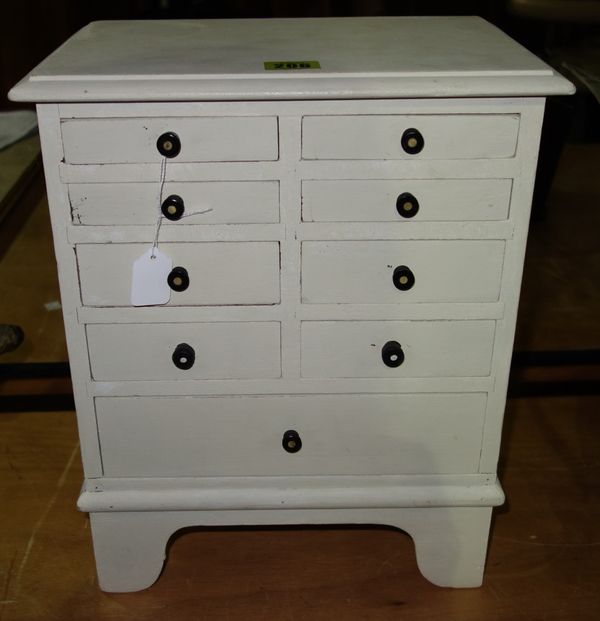 A cream painted miniature chest, 30.5cm wide.