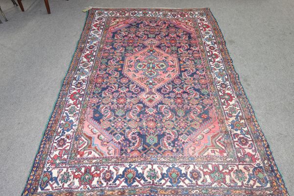 A Hamadan rug, Persian Indigo field, herate design, 218cm x 140cm.