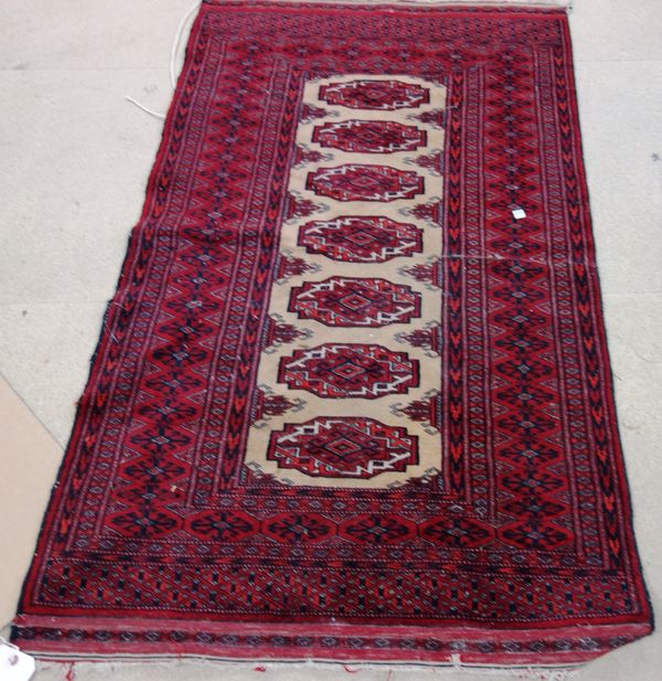 An Indian Bokhara rug, camel field with seven guls, 140cm x 79cm.