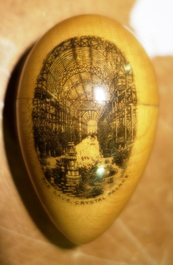 A Mauchline Ware egg shaped thimble case, printed scene 'The Nave Crystal Palace'.