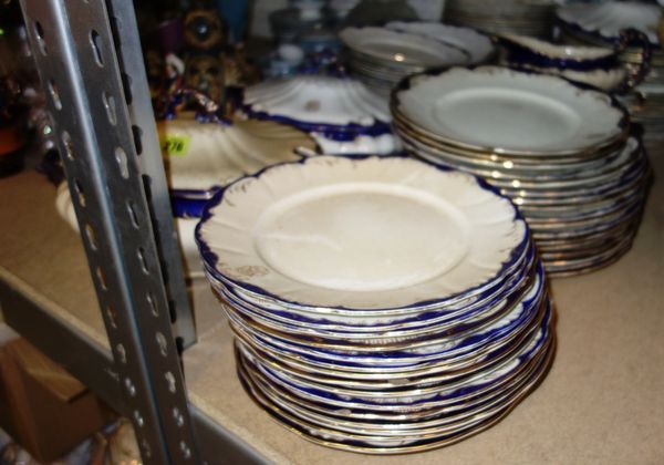 A large quantity of blue and cream gilt dinner wares.