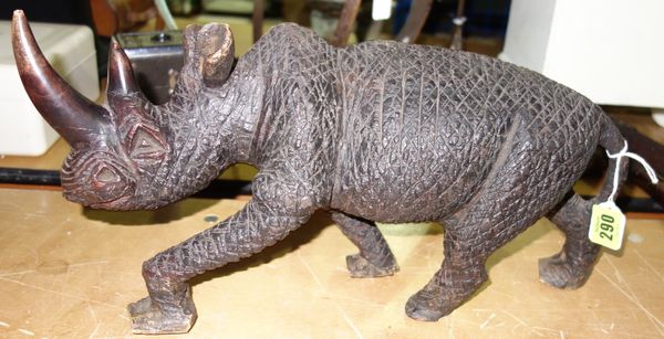A carved hardwood figure of a rhino, with rough textured body, 40cm long.