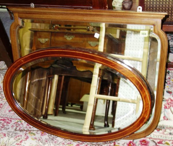 A walnut rectangular mirror and an oval mirror. (2)