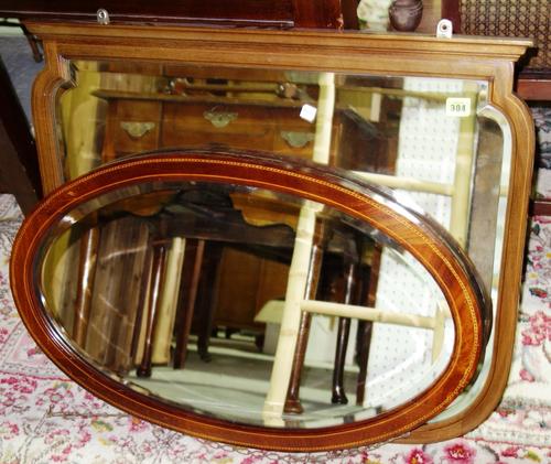 A walnut rectangular mirror and an oval mirror. (2)