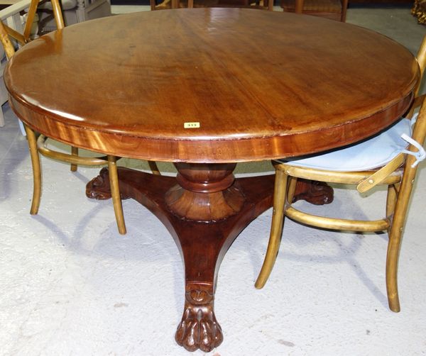 A Victorian mahogany circular snap top breakfast table on octagonal baluster column, resting on lion's paw feet, 121cm wide.