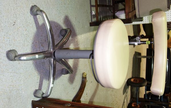 A 20th century cream leather and chrome swivel dentist chairs.