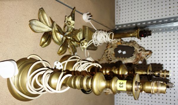A group of metalware collectables including four brass table lamps, pair of cast metal frames moulded with ladies and two brass flower ornaments. (qty