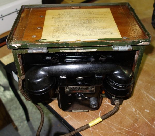 A Military field telephone type F, mark II by Siemans Brothers & Co Ltd, circa 1936, black Bakalite and green painted wood and metal bound case, 28cm